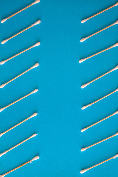 Composition of wooden cotton swabs on a blue-cyan-lilac backgrou - Foto, imagen