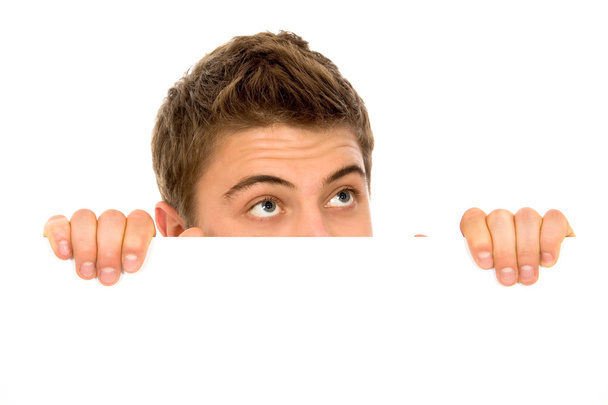 Man peeping over a blank billboard - Zdjęcie, obraz
