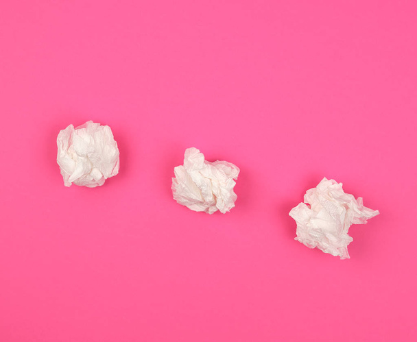three crumpled white paper napkins on a pink background  - Photo, Image
