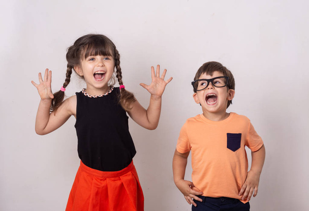Bright kids. Happy boy and girl isolated on grey. Fun kids background. Kid Creativity Education Concept. - Φωτογραφία, εικόνα