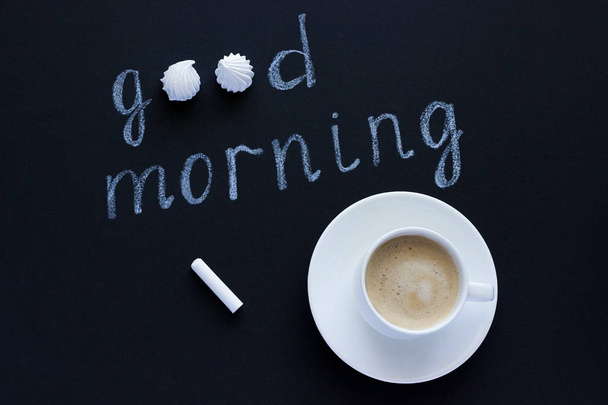 Text Good morning with chalk on black background cup coffee and  - Photo, Image