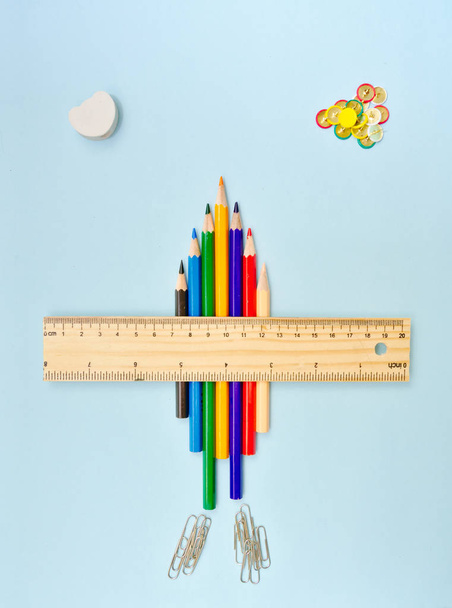 Airplane made whith color pencils and ruler flying on sky with clouds made from eraser and pushpins, back to school consept. - Photo, Image
