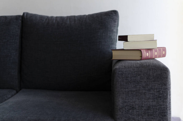 books on the sofa. armchair. glasses. - 写真・画像