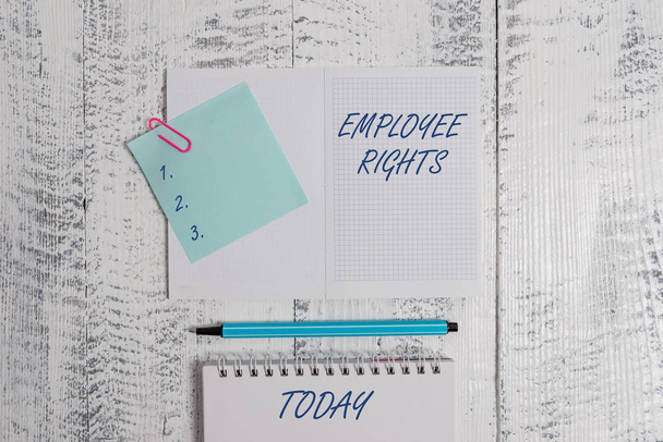 Word writing text Employee Rights. Business concept for All employees have basic rights in their own workplace Open squared spiral notepad clip note highlighter lying old wooden background. - Photo, Image