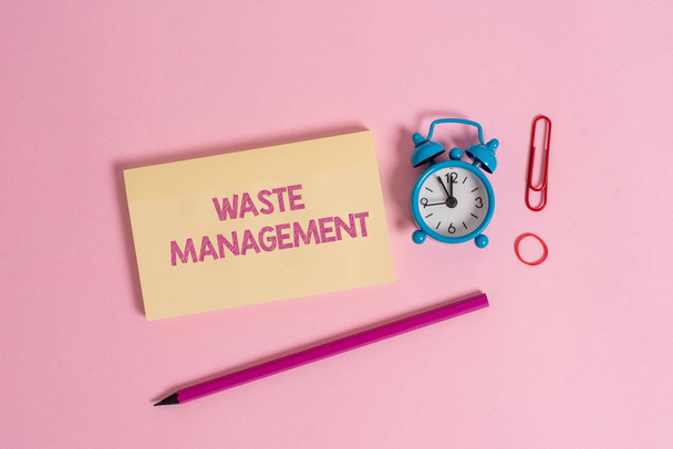 Word writing text Waste Management. Business concept for actions required analysisage rubbish inception to final disposal Colorful blank notepad marker retro alarm clock clip colored background. - Photo, Image