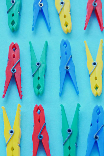 different colored clothespins on colored background  - Photo, Image
