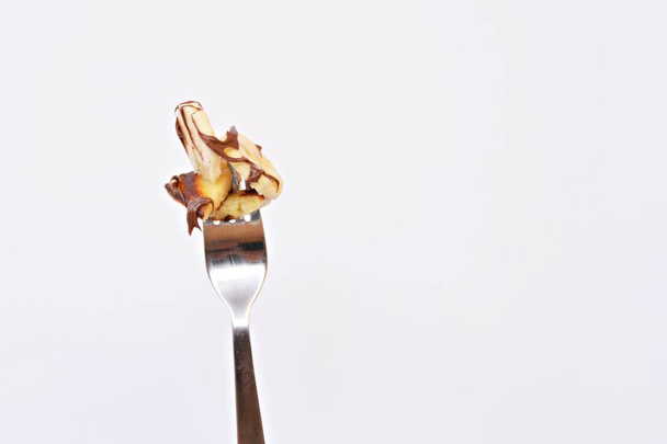 pancake with banana on a fork - Фото, зображення