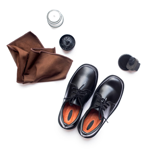 Black leather shoes shoe polish white background - 写真・画像