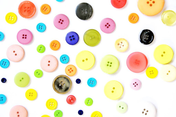 Un gran conjunto de botones en diferentes colores y diseños delante de un fondo de color
  - Foto, imagen