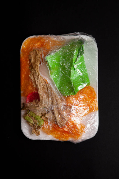 Still life cocnept of food plastic pollution. Creative poster for ban plastic campaign. plastic in the form of food in the package from the supermarket. Eco. recycle concept - 写真・画像