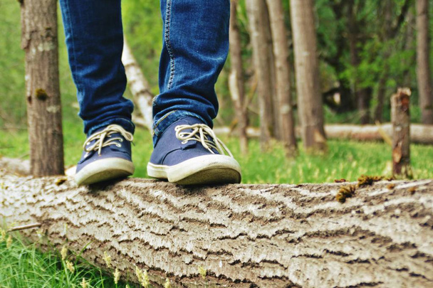 close up of legs in jeans, walking in nature  - Photo, Image