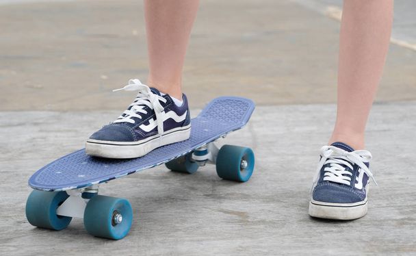 Teen learns to ride a skateboard. - Fotó, kép