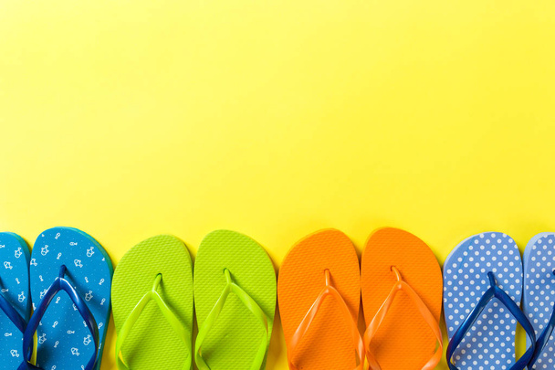 a lot of flip flop colored sandals, summer vacation on colored background, copy space top view - Photo, Image