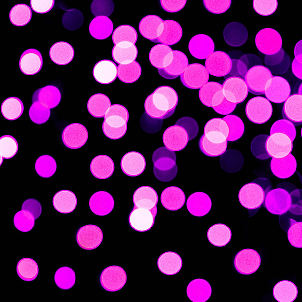 Unfocused abstract purple bokeh on black background. defocused and blurred many round light - Photo, Image