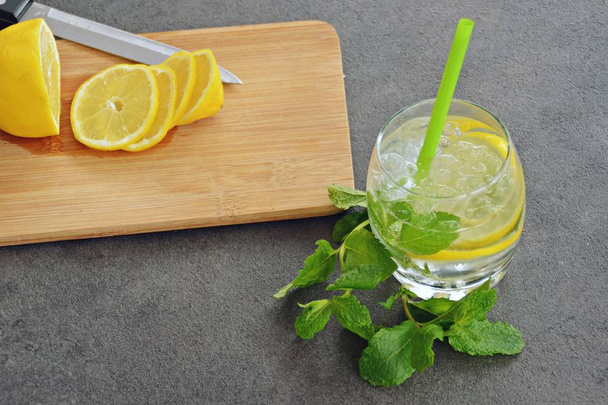summer drink on a wooden table with mint and citrus  - Fotó, kép