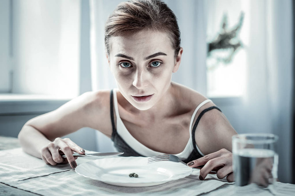 Unhealthy young woman looking straight at camera - Fotoğraf, Görsel