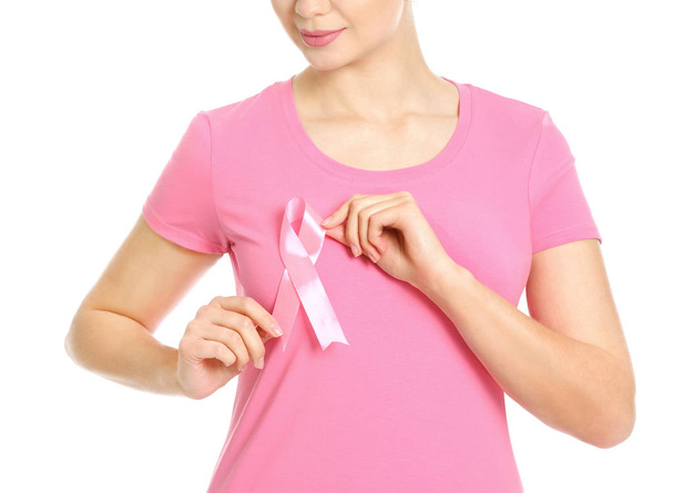 Young woman with pink ribbon on white background. Breast cancer awareness concept - Foto, Bild
