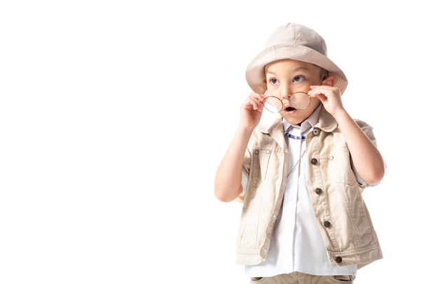 shocked explorer boy in hat and glasses looking away with open mouth isolated on white - Fotografie, Obrázek