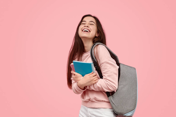 Excited student laughing and hugging notebooks - Photo, image