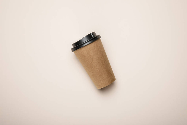 top view of coffee to go on beige background - Foto, Imagen