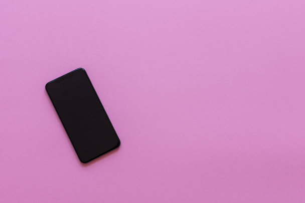 Modern phone on pink background - Fotó, kép