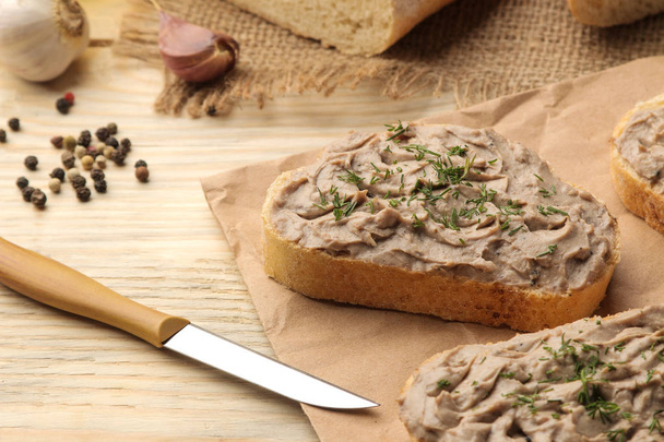 Fresh homemade chicken liver pate with herbs for bread on a natural wooden table. A sandwich. - Photo, Image