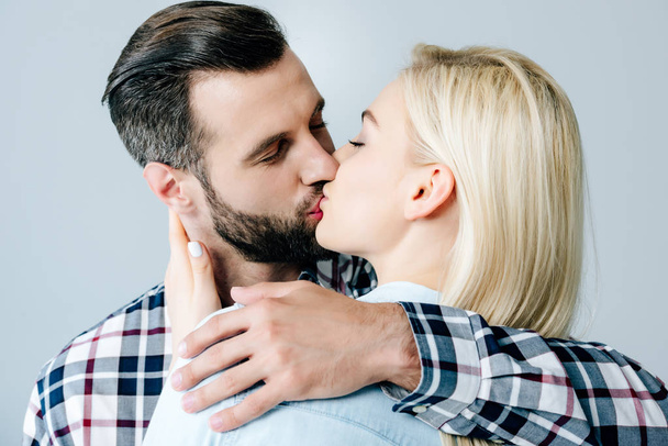 beautiful couple kissing and embracing isolated on grey - Foto, Imagem