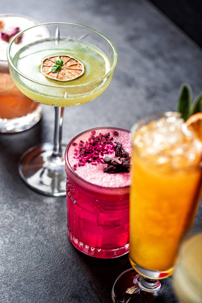 Close up colored cocktails aligned in order - 写真・画像