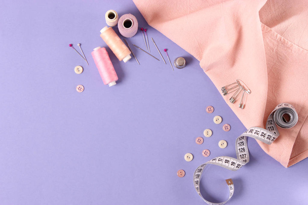 sewing accessories on a colored background top view. - 写真・画像