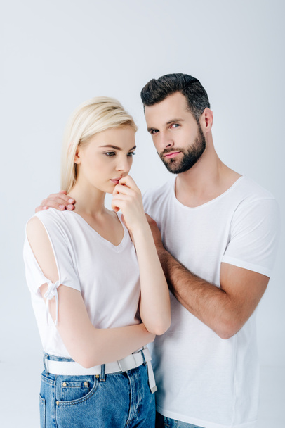 handsome man embracing upset young woman isolated on grey - Photo, Image