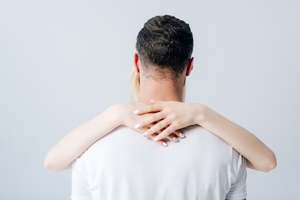 back view of girl embracing man isolated on grey - Фото, изображение