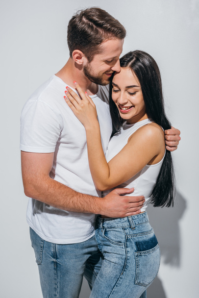 happy couple of two people in love smiling while hugging each other - Fotó, kép