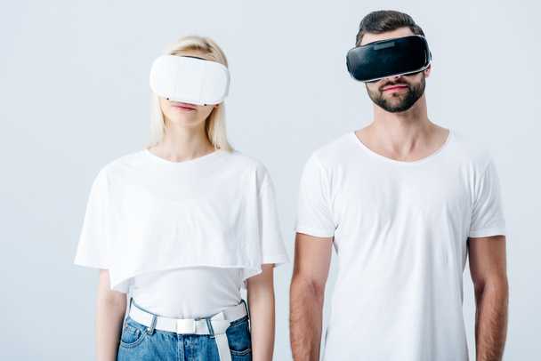 man and girl in Virtual reality headsets isolated on grey - Фото, изображение