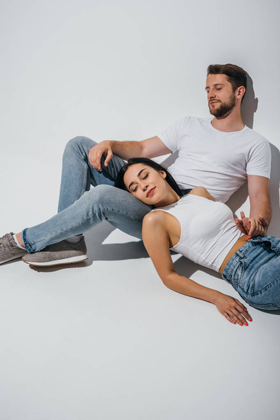 beautiful girl lying on knees of boyfriend with closed eyes - Foto, Imagem