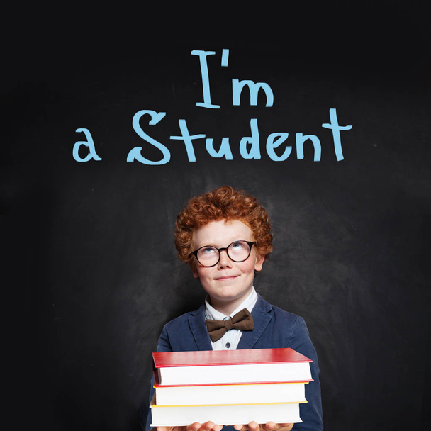 Redhead kid on chalkboard background. Back to school concept - Photo, Image