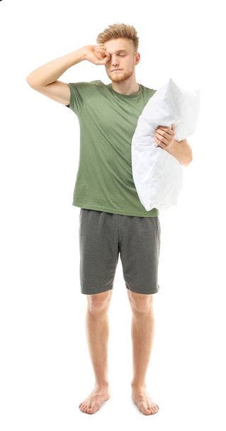 Sleepy man with pillow on white background - Φωτογραφία, εικόνα