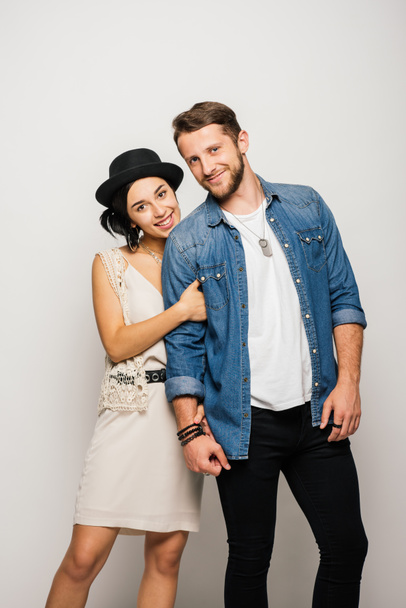 young couple in stylish clothes hugging, smiling and looking at camera  - Foto, Bild
