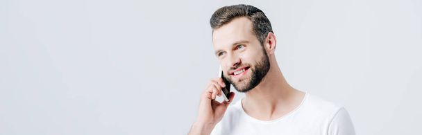 panoramic shot of happy man talking on smartphone isolated on grey - Фото, изображение