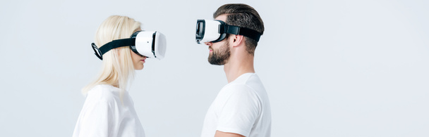 panoramic shot of man and girl in Virtual reality headsets isolated on grey - Φωτογραφία, εικόνα