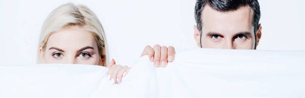 panoramic shot of beautiful girlfriend and handsome boyfriend holding blanket isolated on white - Φωτογραφία, εικόνα