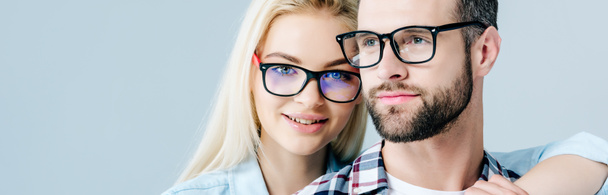 panoramic shot of man and beautiful girl in glasses isolated on grey - Photo, Image
