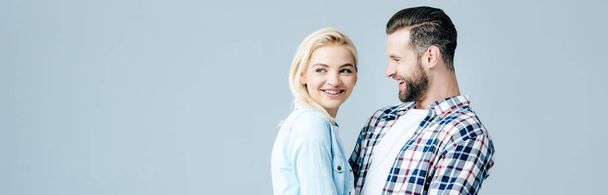 panoramic shot of beautiful young happy couple isolated on grey with copy space - Foto, Bild