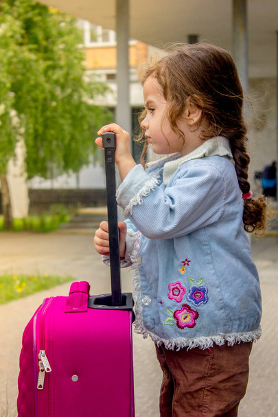 Little kid girl traveler - girl with travel bag. - Φωτογραφία, εικόνα