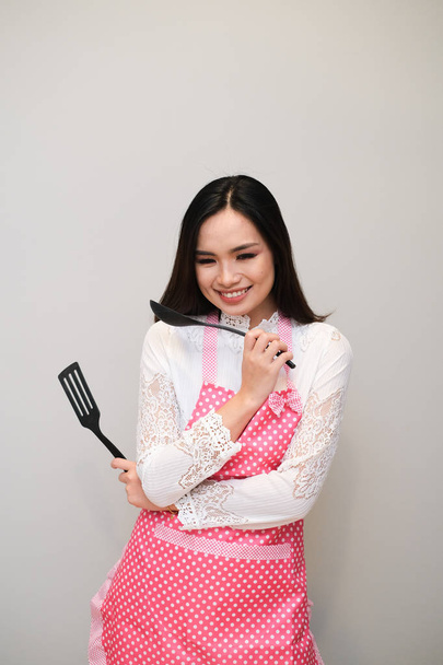 Asian girl with nice outfit, wearing a long polka dot apron. - Photo, Image