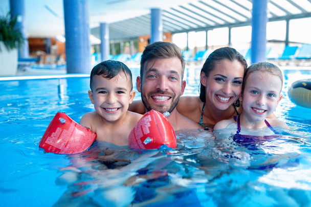 Happy family in the swimming pool - Foto, imagen
