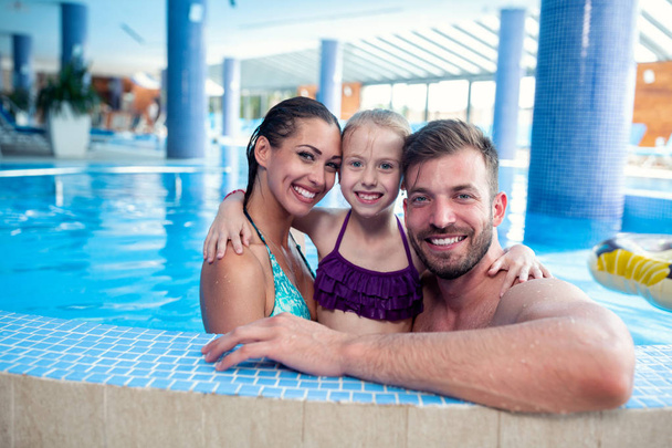 Happy family by the poolside  - Zdjęcie, obraz