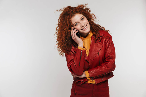 Portrait of happy redhead woman 20s wearing leather jacket smili - Фото, зображення
