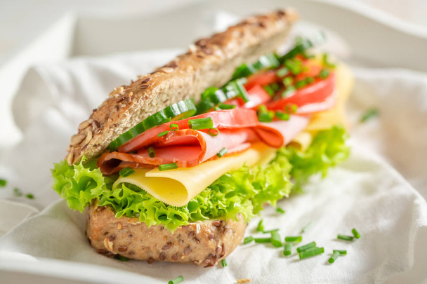 Tasty sandwich with cheese, ham and chive for breakfast - Fotografie, Obrázek