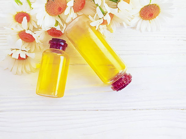 aceite de manzanilla flor cosmética sobre fondo de madera
 - Foto, Imagen