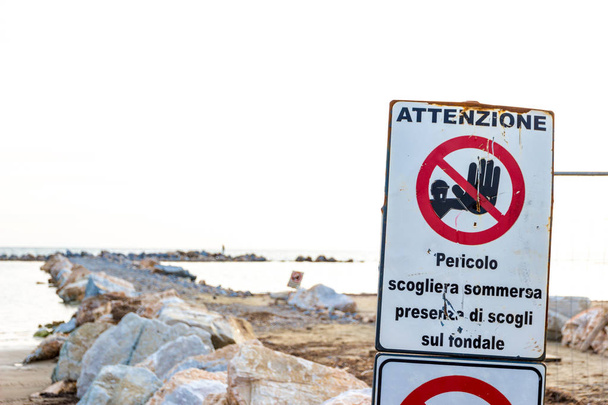 Warning signs on the shoreline in Follonica, Italy - Zdjęcie, obraz